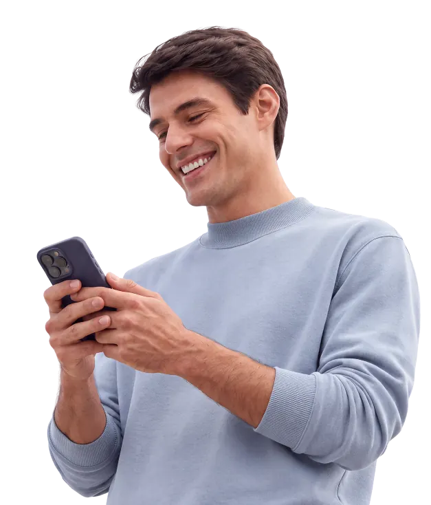 A smiling man checking his phone